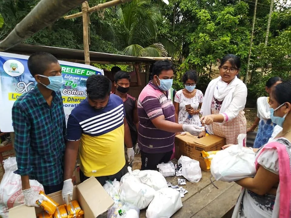 Volunteers distributing relief supplies at a NANF relief drive in Assam