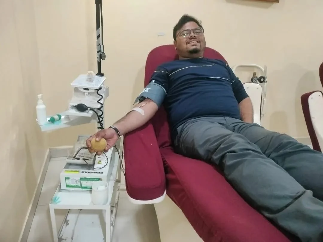 A donor giving blood at a NANF blood donation camp